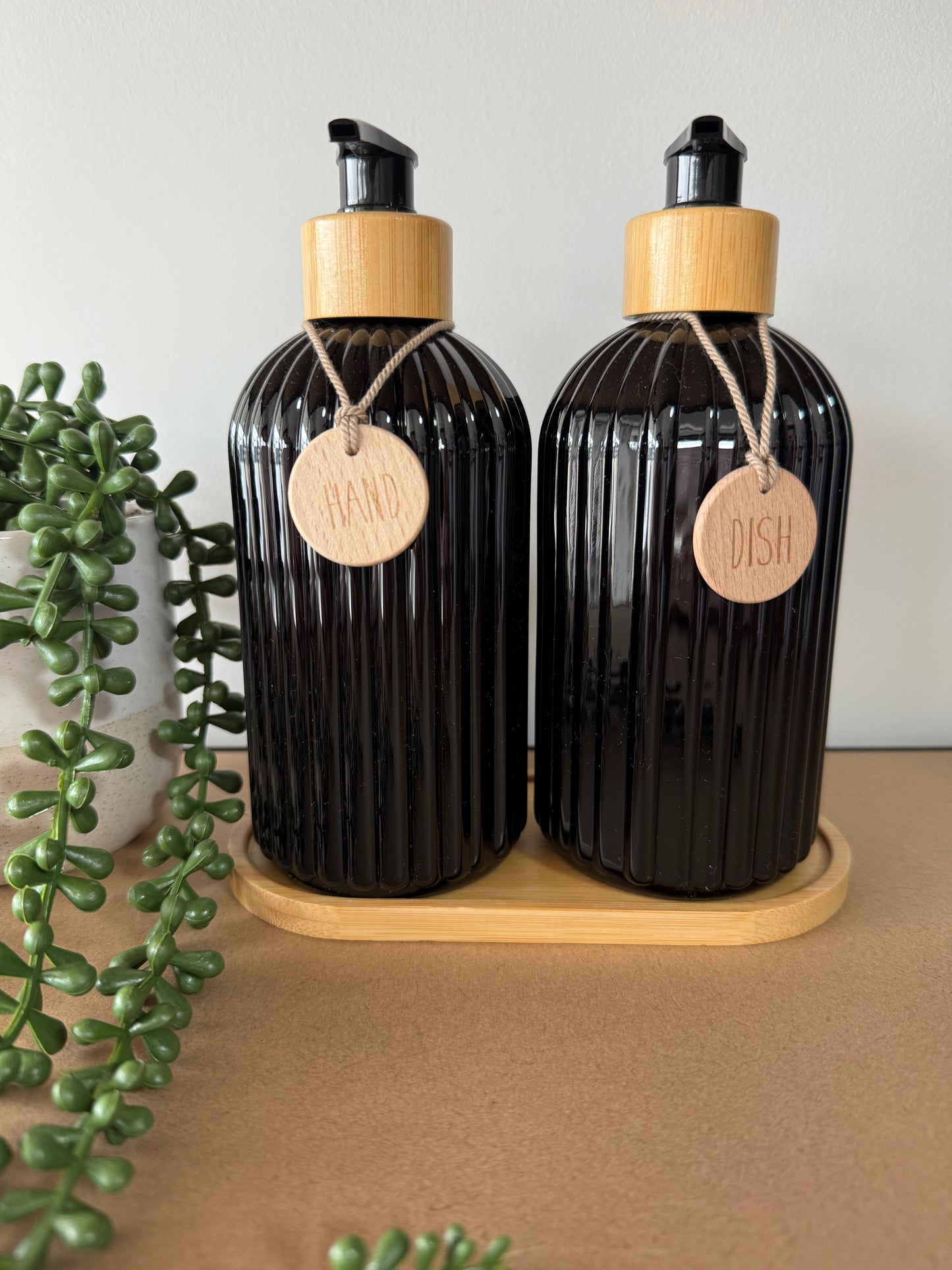 Dispenser bottles with wooden tray
